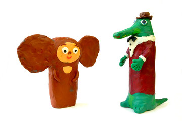 Plasticine figures the Cheburashka and Gena's Crocodile on a white background. Children's creativity