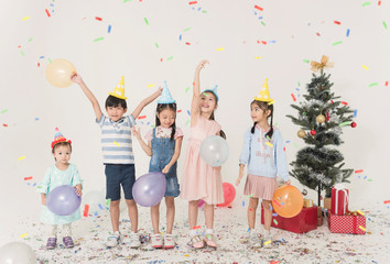 Group of kids celebrate christmas and happy new year party together.