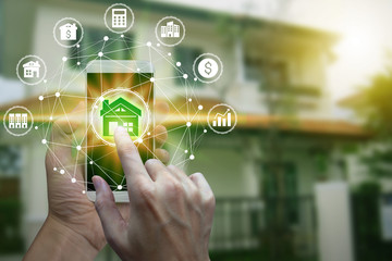 Hand use smartphone with property investment icons