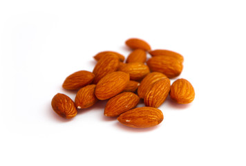 A pile of almond nuts macro view, isolated on white background.