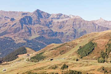 Obraz premium Train descending from Kleine Scheidegg towards Wengernalp station; view from Fallbodensee (Fallboden lake) at Fallboden, Jungfrau Region, Switzerland
