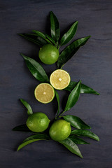 Green limes and lime slices with leaves. Detox vitamins diet