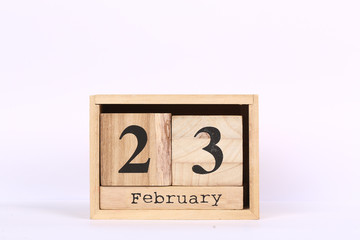 Wooden cubes calendar with the date of February 23. Concept calendar for year with copy space isolated on white background