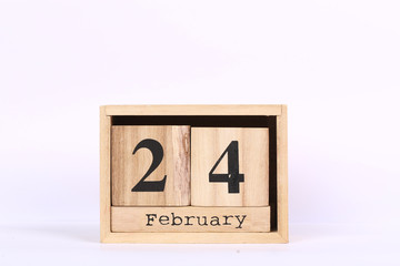 Wooden cubes calendar with the date of February 24. Concept calendar for year with copy space isolated on white background