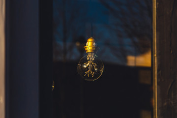 Obraz premium old light bulb glows in the dark close up