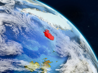 Iceland from space on realistic model of planet Earth with country borders and detailed planet surface and clouds.