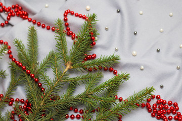 knitted scarf, place for text. rustic christmas tree and woolen clothes. hygge winter look. Red beads.