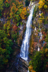 waterfall falling down the cliff in autumn