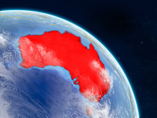 Australia from space on realistic model of planet Earth with country borders and detailed planet surface and clouds.