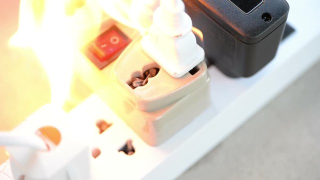 Fire from plugging power cable into overloaded electric outlet
