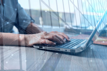 Female hands using a laptop, double exposure