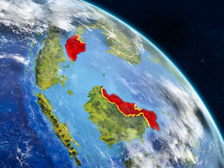 Malaysia from space on realistic model of planet Earth with country borders and detailed planet surface and clouds.
