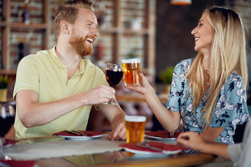 Couple making a toast while sitting in restaurant.