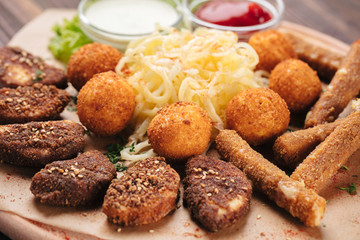 Big plate with breaded cheese and potato balls