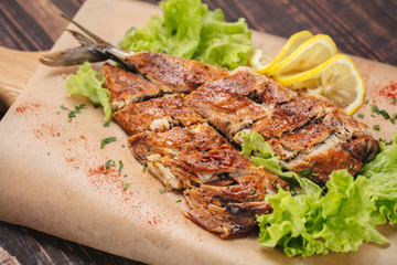 Grilled mackerel served on backing paper