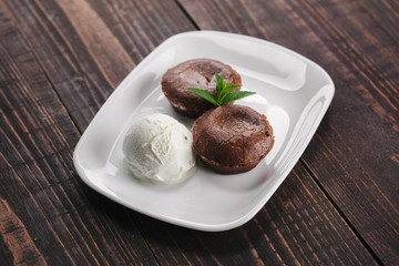 Chocolate fondant served with ice cream on a white plate