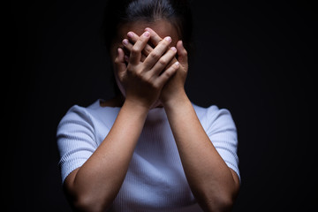 Sadness of a woman in the dark