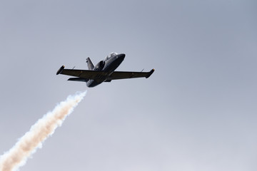 Low angle view of airshow in cloudy sky