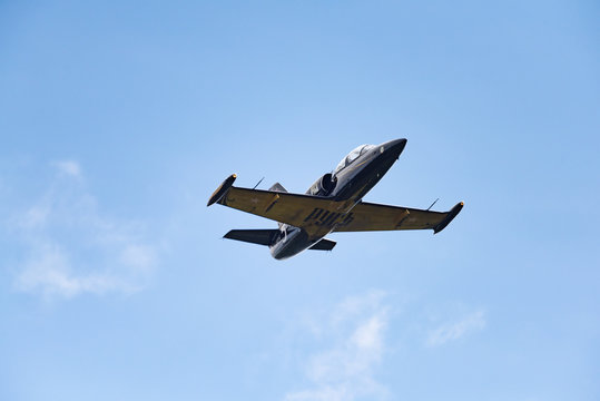 Low angle view of airshow in cloudy sky