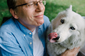 white husky kisses her master