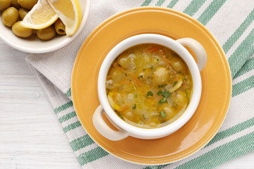 Vegetarian soup with olives and lemon