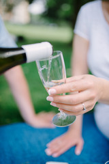 Pouring champagne into glass at hen-party, close up
