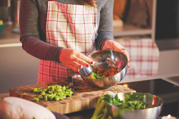 Young Woman Cooking in the kitchen. Healthy Food for Christmas (stuffed duck or Goose)