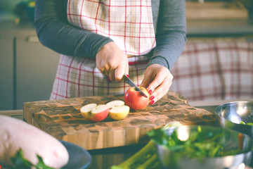 Young Woman Cooking in the kitchen. Healthy Food for Christmas (stuffed duck or Goose)