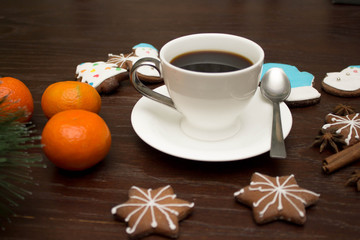 Gingerbread cookies hanging over wooden background