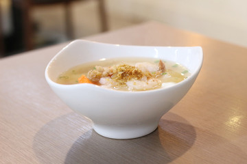 Shrimp porridge on wooden background.