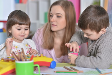 Fototapeta premium Portrait of a mother with children playing together