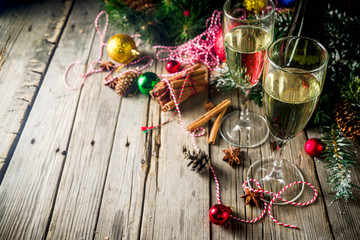 Obraz na płótnie Canvas Two glasses of champagne with Christmas decoration on wooden background, Happy New Year and Xmas Celebration. Copy space