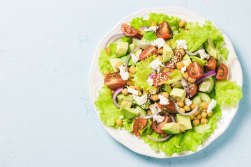 Chickpea cherry tomato goat cheese salad. Top view, space for text.