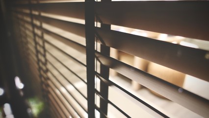 Evening sun light outside and wooden window blinds, sunshine and shadow on window blind, decorative interior home concept