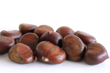Fresh chestnuts on a white background. Isolated chestnut set. The name also refers to the edible nuts they produce. Concept of healthy and seasonal food. Autumn decorations.