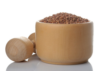 Buckwheat in a wooden mortar on a white isolated background. porridge. healthy food. cereals.