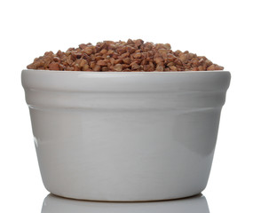 Buckwheat groats in a white bowl on a white isolated background. porridge. healthy food. cereals.