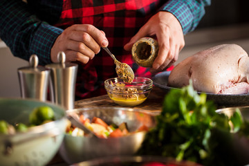 Man preparing delicious and healthy food in the home kitchen for christmas (Christmas Duck or Goose)
