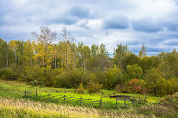 Fototapeta na wymiar Beautiful rural autumn landscape with a cloudy sky, Russia.