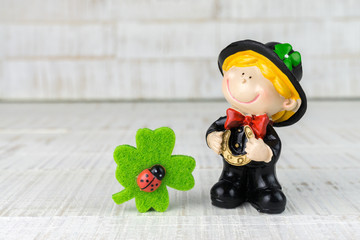Small chimney sweep with four-leaf clover as good luck charm