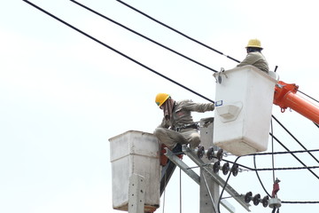 NONTHABURI, THAILAND - APRIL 29, 2017: Electrician are installing high powered electric cables to cope with the increasing power usage of people in the community