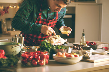 Man preparing delicious and healthy food in the home kitchen for christmas (Christmas Duck or Goose)