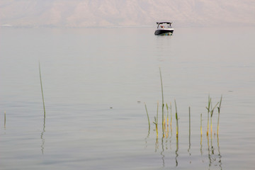 An open pleasure boat fishing on the Sea Of Galilee Israel