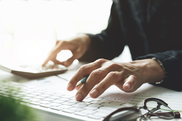 Close up view of bookkeeper or financial inspector hands making report, calculating or checking balance. Home finances, investment, economy, saving money or insurance concept