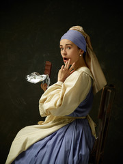 Medieval woman in historical costume wearing corset dress and bonnet. Beautiful peasant girl...