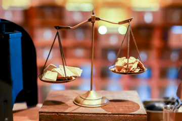 Ancient scales with the weight balance put on wooden table.