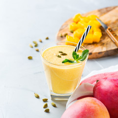 Mango lassi, indian drink, smoothie beverage with yogurt