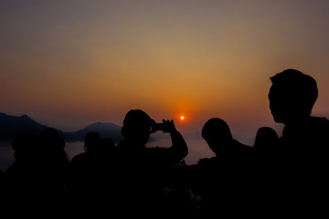 beautiful Silhouette and Tourists are watching the sea fog And sunrise