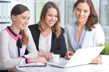 Fototapeta premium Portrait of young women sitting at table