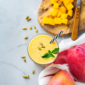 Mango lassi, indian drink, smoothie beverage with yogurt